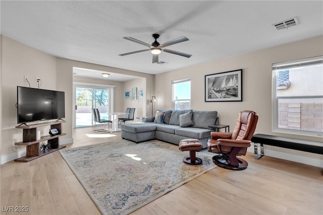 living room with ceiling fan and hardwood / wood-style floors