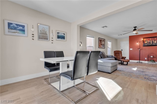 living room with light hardwood / wood-style floors and ceiling fan