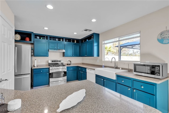 kitchen with blue cabinets, appliances with stainless steel finishes, and sink