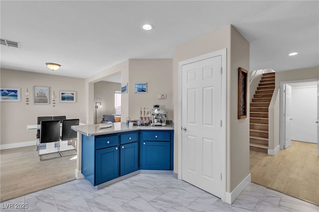 kitchen with blue cabinets and kitchen peninsula