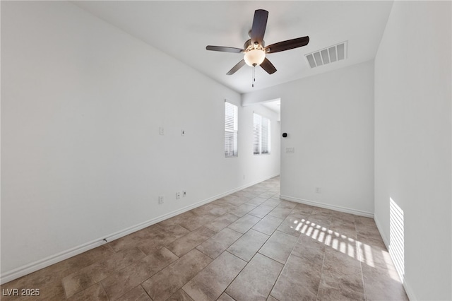 tiled spare room featuring ceiling fan