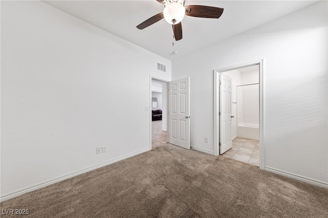 unfurnished bedroom featuring ensuite bath, ceiling fan, and light carpet