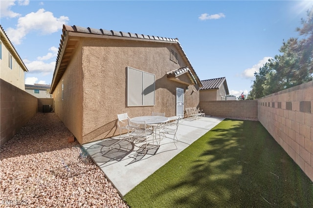 back of house with a patio