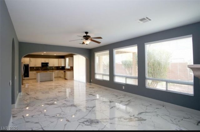 unfurnished living room with ceiling fan