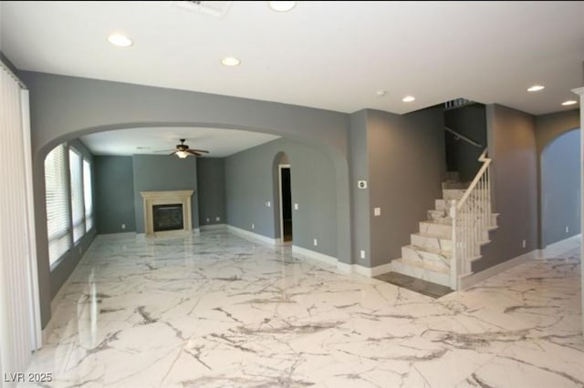 unfurnished living room featuring ceiling fan