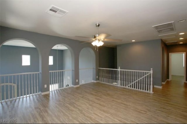 spare room with ceiling fan and hardwood / wood-style flooring