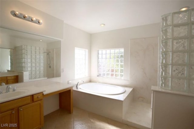 bathroom with tile patterned flooring, vanity, and shower with separate bathtub