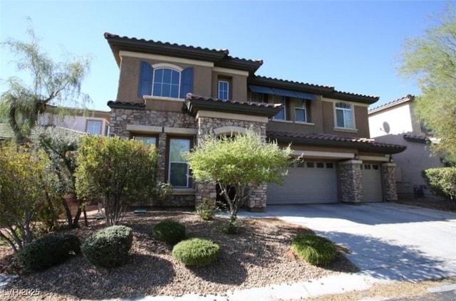 mediterranean / spanish-style home with a garage