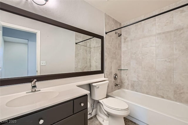 full bathroom with toilet, tiled shower / bath, and vanity