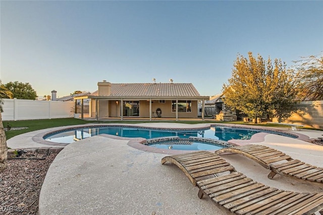 view of swimming pool featuring a patio and an in ground hot tub