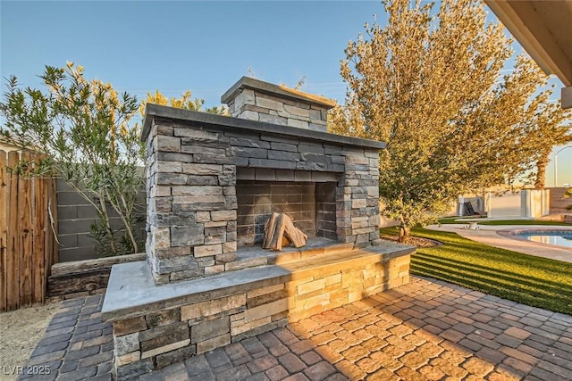 view of patio / terrace featuring an outdoor stone fireplace