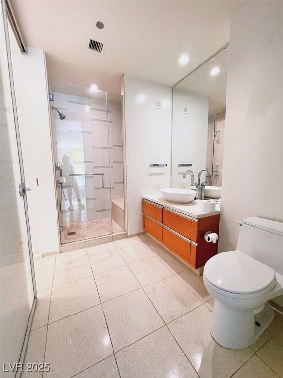 bathroom featuring walk in shower, vanity, and toilet