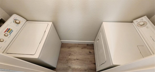 clothes washing area with hardwood / wood-style flooring