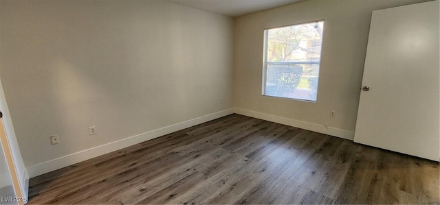 unfurnished room featuring dark hardwood / wood-style flooring