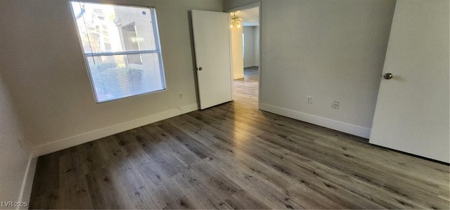 unfurnished room with hardwood / wood-style flooring