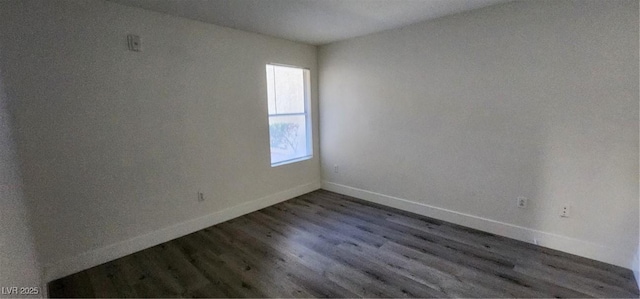 spare room featuring dark hardwood / wood-style floors