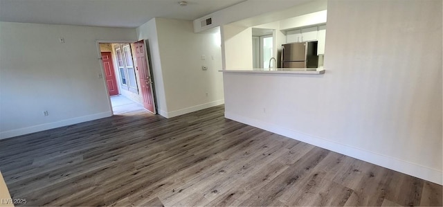 spare room featuring sink and hardwood / wood-style floors