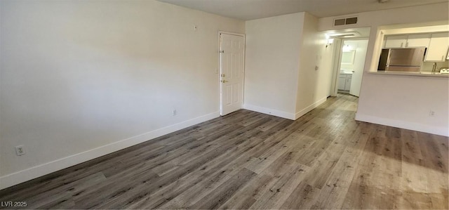 spare room featuring hardwood / wood-style floors