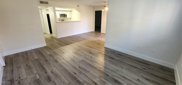 spare room with ceiling fan and wood-type flooring