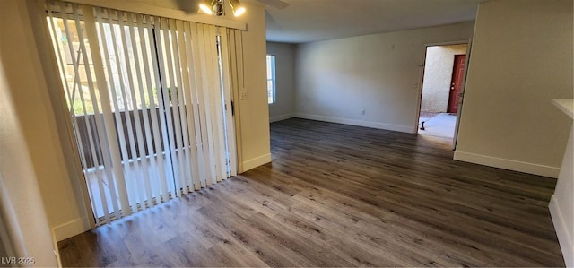 unfurnished room with ceiling fan, a healthy amount of sunlight, and dark hardwood / wood-style floors