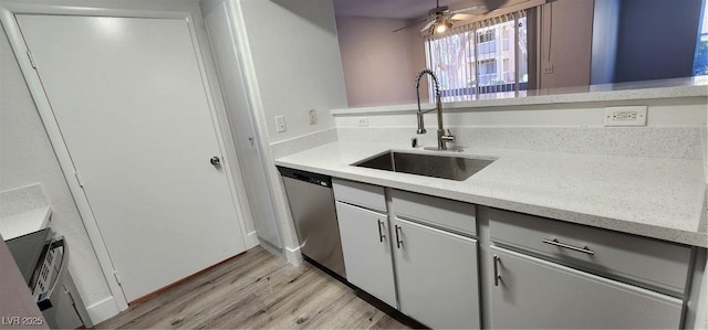 kitchen featuring sink, white cabinets, ceiling fan, light hardwood / wood-style flooring, and stainless steel dishwasher