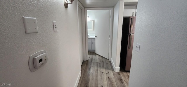 corridor with light hardwood / wood-style flooring