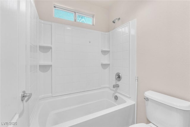 bathroom with toilet and  shower combination