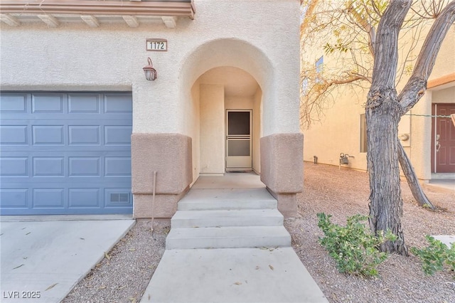 doorway to property featuring a garage