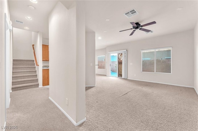 unfurnished living room with ceiling fan and light colored carpet