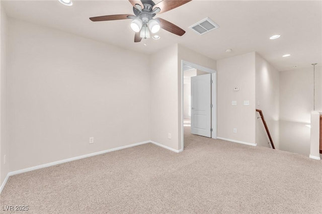 spare room featuring ceiling fan and carpet flooring