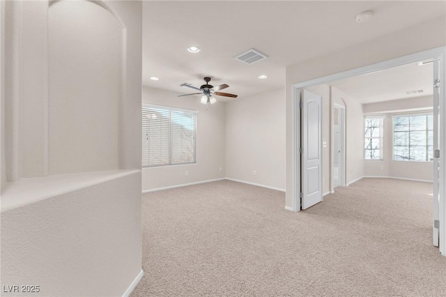 carpeted spare room with ceiling fan