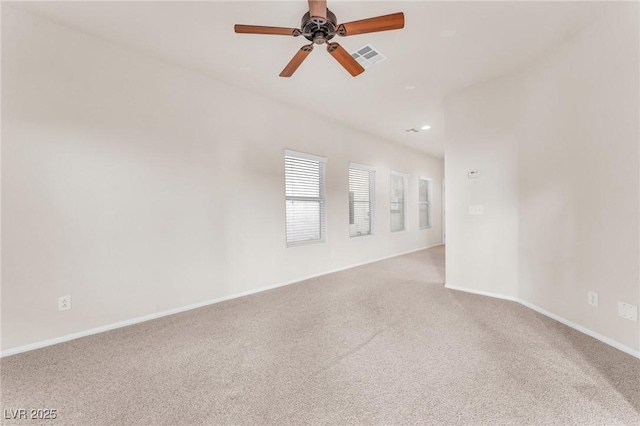 carpeted spare room featuring ceiling fan