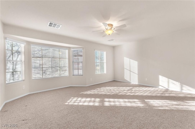 carpeted empty room featuring ceiling fan