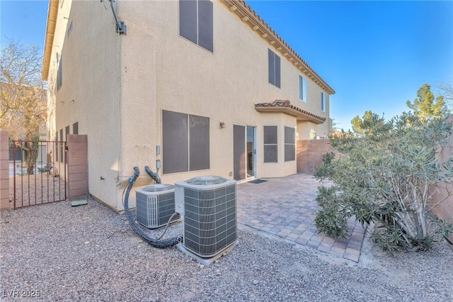 back of house featuring central AC unit and a patio area