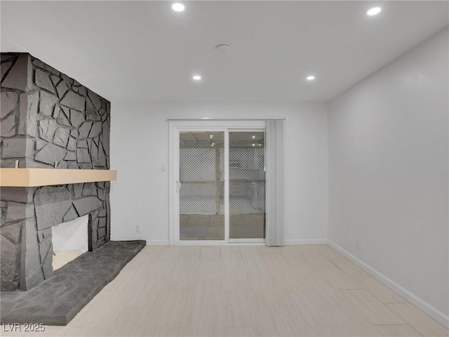 living room featuring a stone fireplace