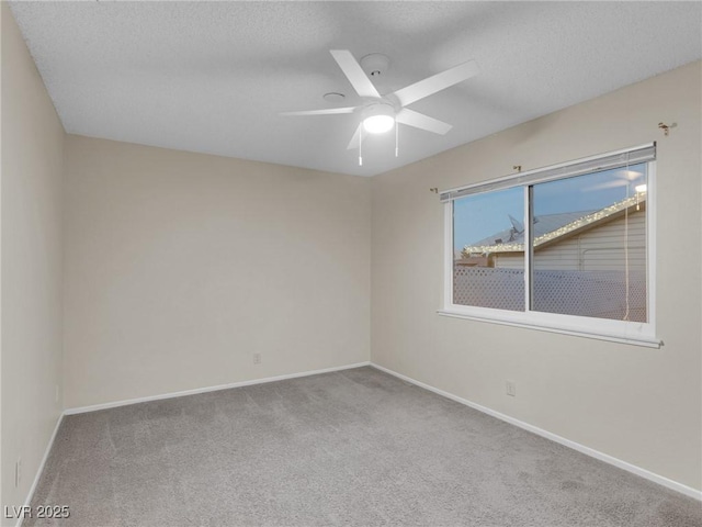 unfurnished room with a textured ceiling, ceiling fan, and carpet flooring