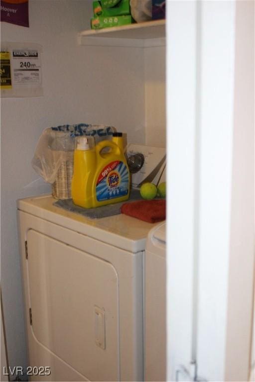 clothes washing area featuring washer and dryer