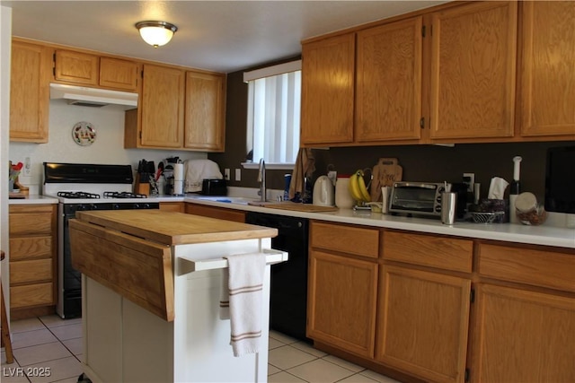 kitchen featuring sink, light tile patterned floors, range with gas cooktop, and black dishwasher