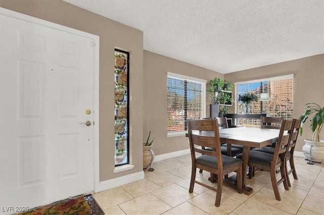 tiled dining room with a textured ceiling