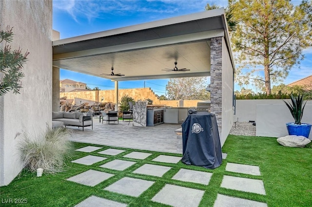 view of patio / terrace featuring ceiling fan, outdoor lounge area, an outdoor kitchen, and grilling area