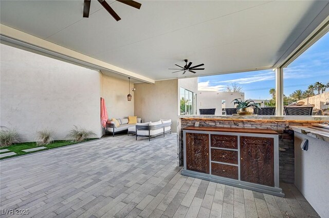 view of patio / terrace featuring ceiling fan and an outdoor living space