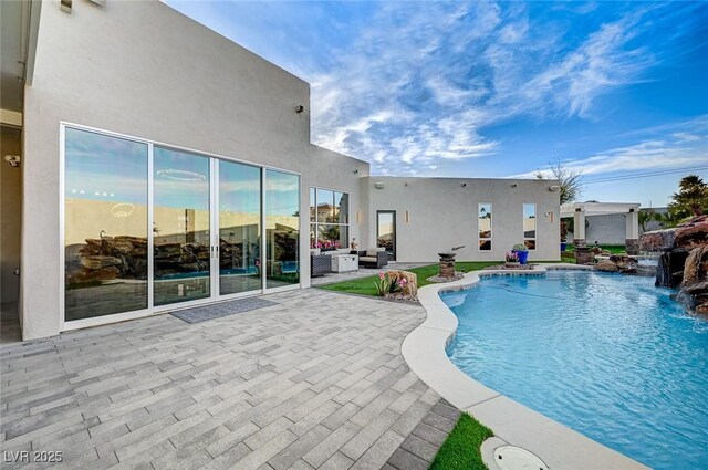 view of swimming pool featuring a patio and pool water feature