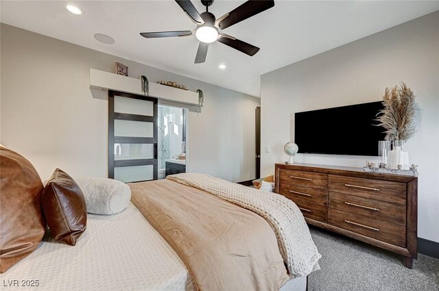 bedroom featuring ceiling fan, connected bathroom, and dark carpet