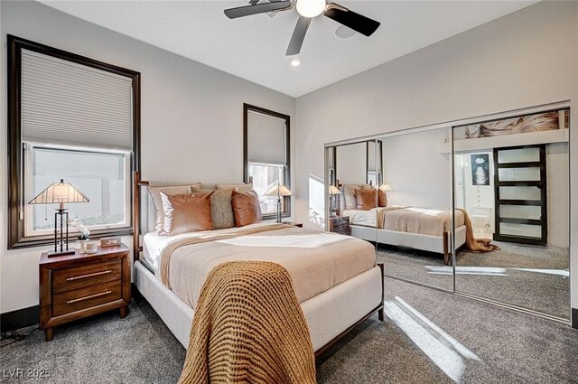 bedroom with dark carpet, ceiling fan, and a closet