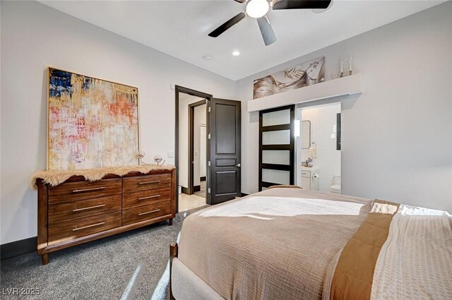 bedroom featuring ensuite bathroom, carpet floors, and ceiling fan