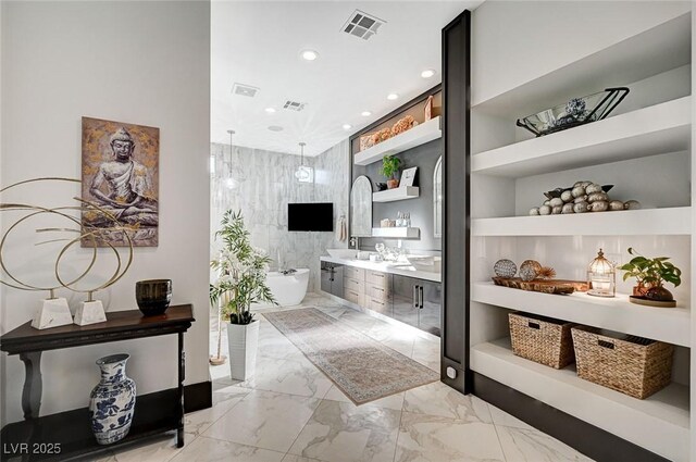 bathroom featuring tile walls, built in shelves, independent shower and bath, and vanity