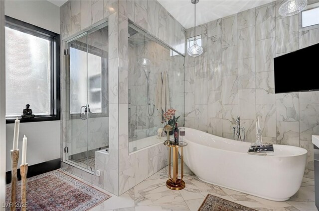 bathroom featuring separate shower and tub