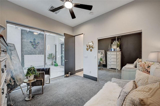 living room featuring ceiling fan and carpet