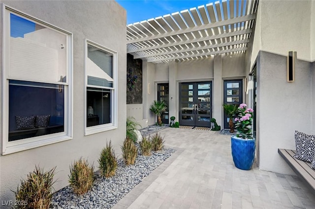 view of patio / terrace featuring french doors and a pergola