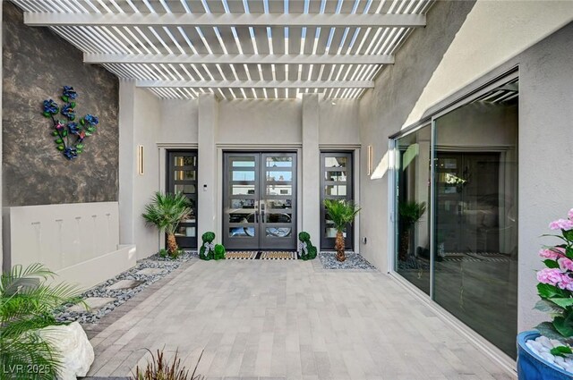 view of patio featuring french doors and a pergola